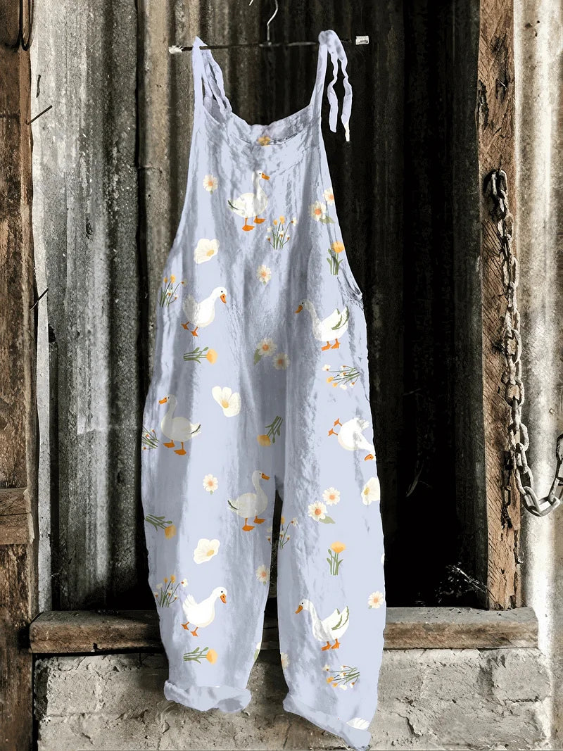 Solea | Lightweight artisanal jumpsuit in soft blue with goose & wildflower print